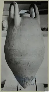 Pottery pithos with two loop handles and a pointed base, standing on a metal stand