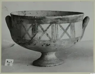 Pottery White Painted I bowl on a pedestal foot, with two loop handles and painted crosses and vertical stripes