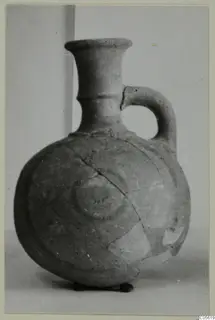 Pottery Polychrome Lustrous Foreign jug with a single loop handle, flared neck and concentric rings on the body