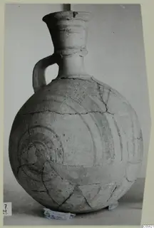 Jug from Amathus with dark painted concentric circles and a loop handle, photographed on a mount