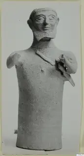 Terracotta figurine of a bearded figure with a cylindrical body and one raised arm, from Ayia Irini