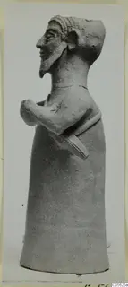 Terracotta figurine of a bearded figure with arms folded across the body, shown in profile.