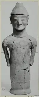 Terracotta statuette of a standing figure with a conical cap and arms at its sides, from Ayia Irini
