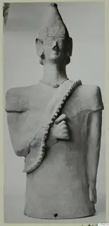 Terracotta Proto-Cypriote II, a standing figure with a tall conical headdress and a notched band across the chest