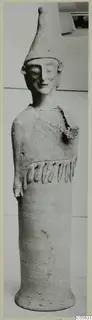 Terracotta figure with a tall conical head and a cylindrical body on a flaring base, photographed upright