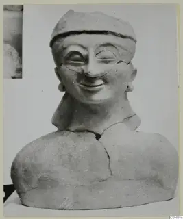 Terracotta bust of a smiling figure wearing a cap-like head covering and earrings, from Ayia Irini