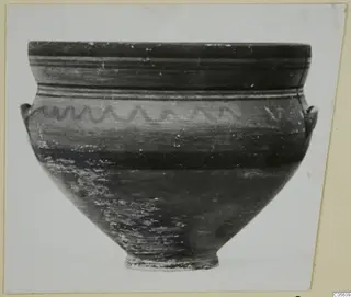 Pottery bowl with a wavy painted line on the upper body and two small handles at the shoulder