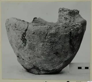 Broken pottery vessel from Marion with an uneven rim, shown beside a scale bar