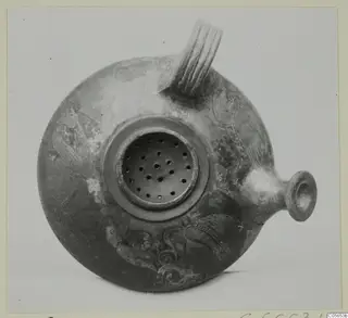 Round pottery vessel with a ribbed strap handle, a small spout and a pierced disc on top, decorated with painted motifs.
