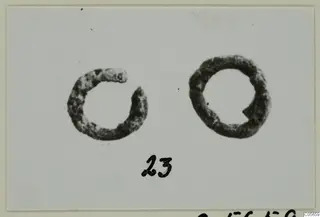 Two silver hair-rings from Marion, photographed on a pale card with a number label below.