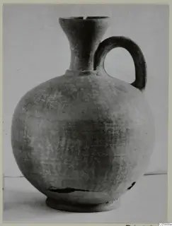 Jug in Pottery Stroke Polished Ware with a globular body, flaring neck and loop handle