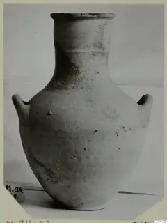 Pottery Plain White VII amphora from Marion, with two handles and a tall neck, photographed against a plain backdrop.