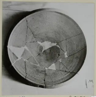 Pottery Plain White VII bowl, broken and mended with white filler, seen from above.