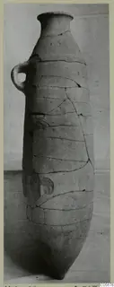 Tall reconstructed pottery pithos from Marion with a narrow neck and a single loop handle, photographed against a plain backdrop