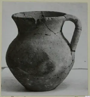 Pottery jug with a single handle and a wide mouth, cracked across the neck and shoulder