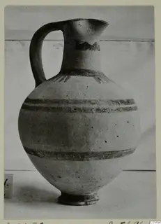 Pottery White Painted I jug with a single handle, a globular body and horizontal painted bands.