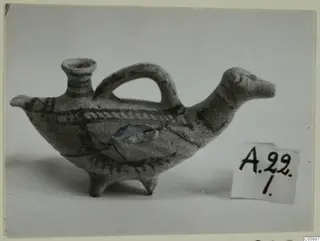 Small bird-shaped clay vessel with a loop handle and painted bands, from Amathus tombs 10–26