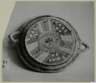 Pottery Bichrome II plate from Amathus seen from above, with radiating painted bands and checkerboard panels