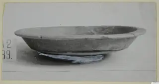 Shallow bowl with a wide rim, photographed on a plain background; find from Amathus tombs 1–9