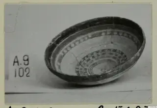 Pottery Polychrome bowl from Amathus, shown tilted to reveal concentric bands and dotted decoration inside.