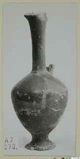 Jug with a tall narrow neck and rounded body from Amathus, shown on a plain background
