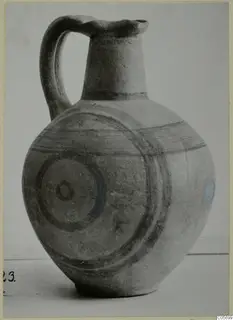 Pottery Black-on-Red II-IV jug with a strap handle, dark painted bands and concentric circles on the body