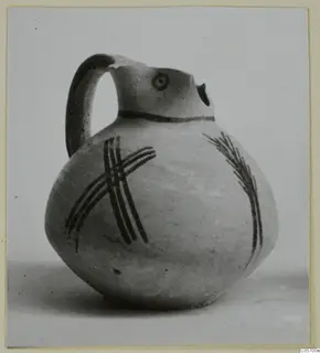 Jug in White Painted IV ware from Amathus, with a strap handle and dark painted bands on a pale body
