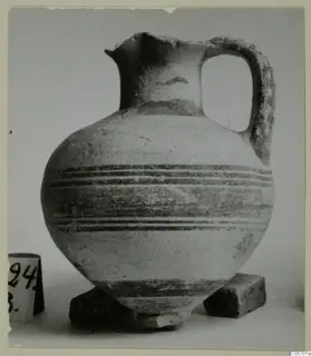Pottery Bichrome I jug from Amathus with dark horizontal bands and a loop handle, photographed against a plain background