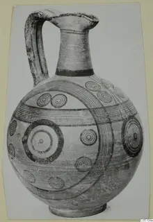 Pottery jug with a tall neck, strap handle and painted concentric circles and bands