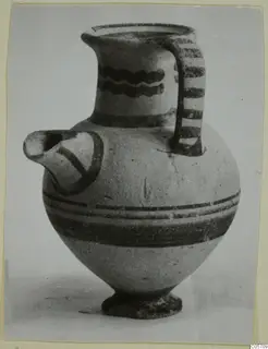 White Painted II jug from Amathus, tombs 10–26, with wavy neck bands and a striped strap handle
