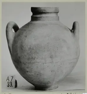 Two-handled jar against a light backdrop, with a number label at its base.