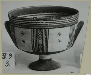 Pottery Bichrome III footed bowl with two side handles, painted bands, vertical stripes and hooked cross motifs