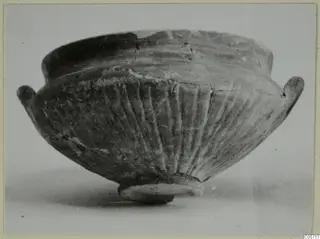 Black Slip bowl with two small handles and vertical fluting on the body, from Amathus tombs 10–26