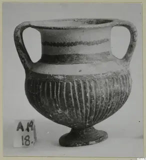 Two-handled footed vessel with a fluted lower body and painted bands, from Amathus