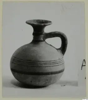 Pottery White Painted IV juglet from Amathus, with a flaring rim, single handle and dark painted bands