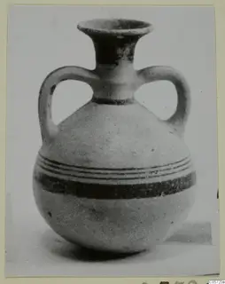 Two-handled jug with a flared neck and dark painted bands around the rounded body, photographed on a pale ground