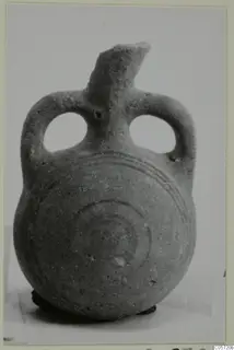 Small bottle with two loop handles and dark concentric circles painted on the body, from Amathus