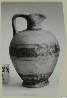 White Painted I jug with a strap handle, a trefoil-type spout and dark painted bands around the body