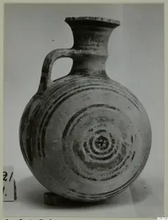 Pottery Bichrome I jug from Amathus, round body with concentric dark bands painted on it and a single loop handle.