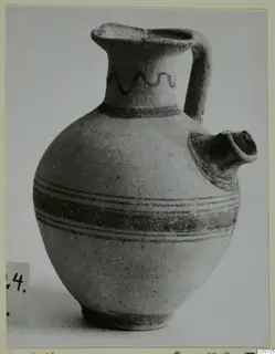 Pottery Bichrome I jug from Amathus with a painted wavy line on the neck and bands around the body