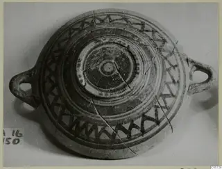 Pottery Bichrome III bowl from Amathus, shallow with two loop handles and dark painted zigzag bands around the rim
