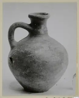 Pottery jug with a flared rim, single loop handle and rounded body, from Amathus