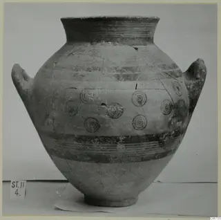 Two-handled pottery jar with concentric circle motifs and painted bands, from Stylli