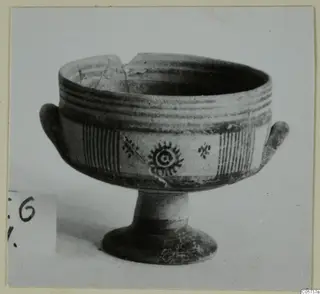 Pottery Bichrome III bowl on a pedestal foot, with painted bands, hatched panels and a rayed central motif.