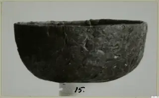 Bowl from Marion Tomb 97, shown in side view with a handwritten number label beneath it.