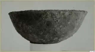 Bowl from Marion, shown in side view on a plain stand.