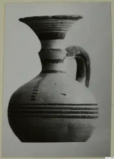 Pottery Black-on-Red I-III: a jug with a flared mouth, dark painted bands and a strap handle, from Amathus tombs 1-9