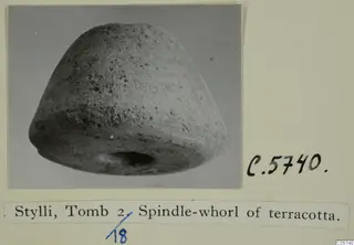 Spindle-whorl of terracotta from Stylli Tomb 2, shown on an album card