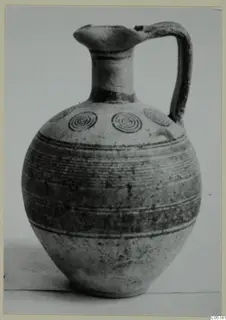 Jug of Pottery Bichrome IV with a banded body and concentric circles on the shoulder, photographed against a plain background