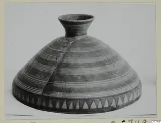 Pottery Bichrome V vessel with a broad conical body, narrow neck and horizontal bands of lines